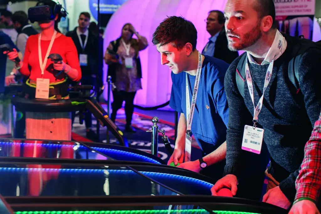 A guest celebrating a win at LED table football